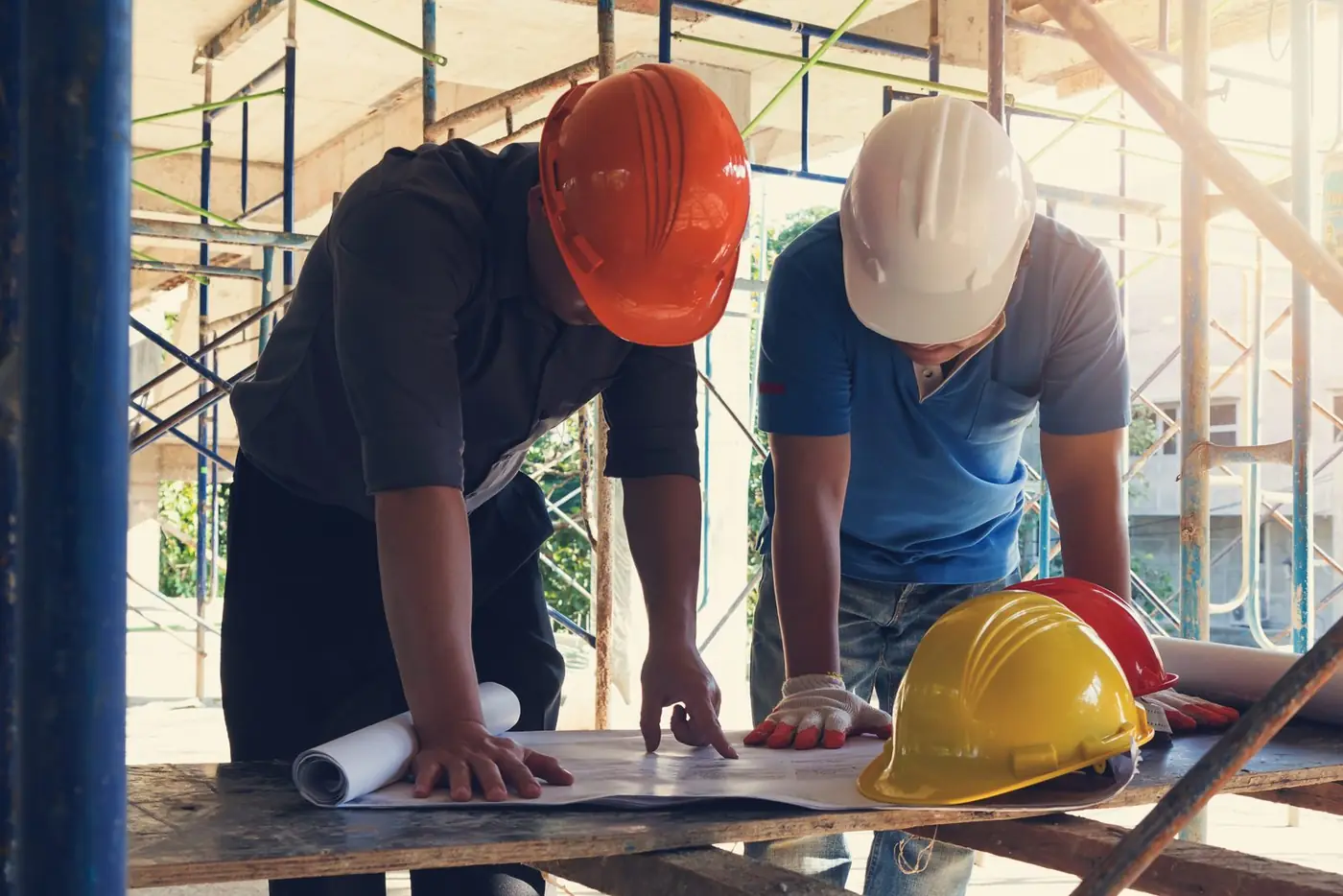 Bauleiter prüfen Pläne auf der Baustelle